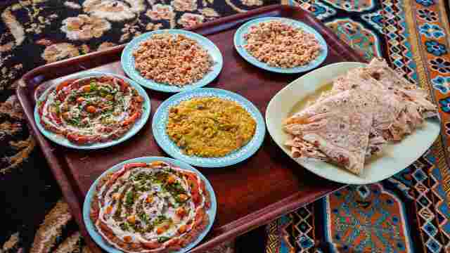 Delicious-dishes-of-traditional-omani-food-served-on-carpet-in-traditional-restaurant-Oman