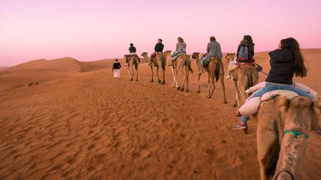 Group-of-tourists-ride-desert-dunes-Salalah-Oman-by-Travelstoyou