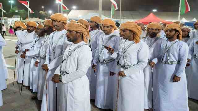 Men-wearing-Omani-dress-and-prepare-to-perform-a-traditional-dance-a-the-Salalah-Tourism-Festival-in-Oman-Travelstoyou-Salalah