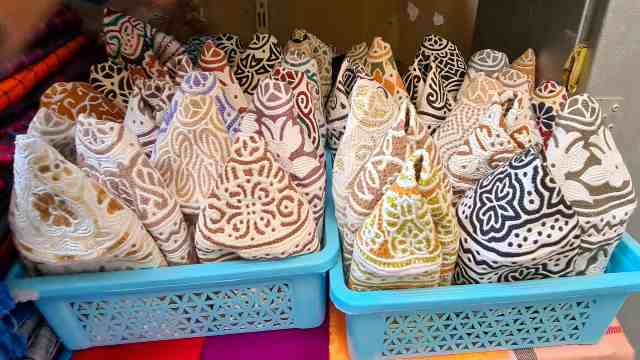Oman Boxes with Kumas, the traditional Omani hat, in Mutrah Souk in Muscat.