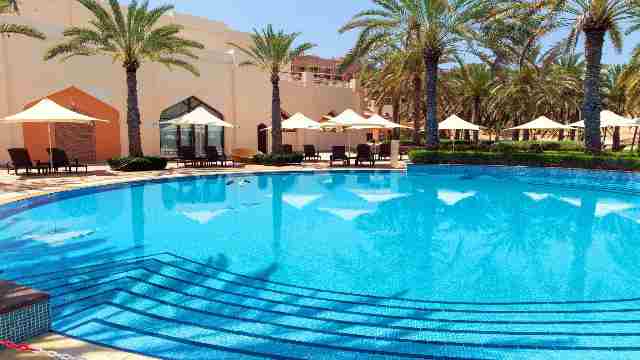 Swimming-pool-with-clear-water-surrounded-by-palm-trees-in-one-of-the-best-resorts