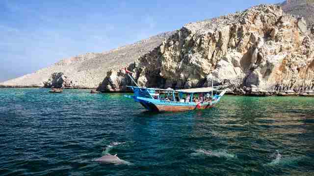 Exploring Captivating Traditions and Tours in Salalah 22 Tourist-seeing-dolphins-from-boat
